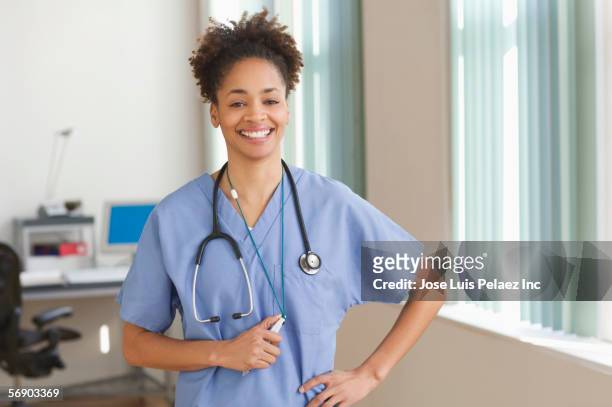 female medical assistant wearing scrubs - auscultation woman stock pictures, royalty-free photos & images