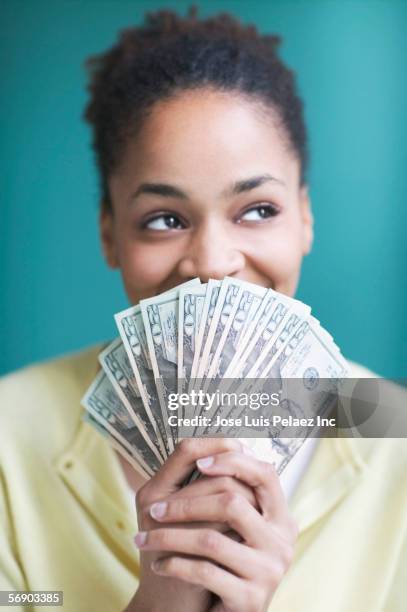 young woman holding twenty dollar bills - big spender stock pictures, royalty-free photos & images