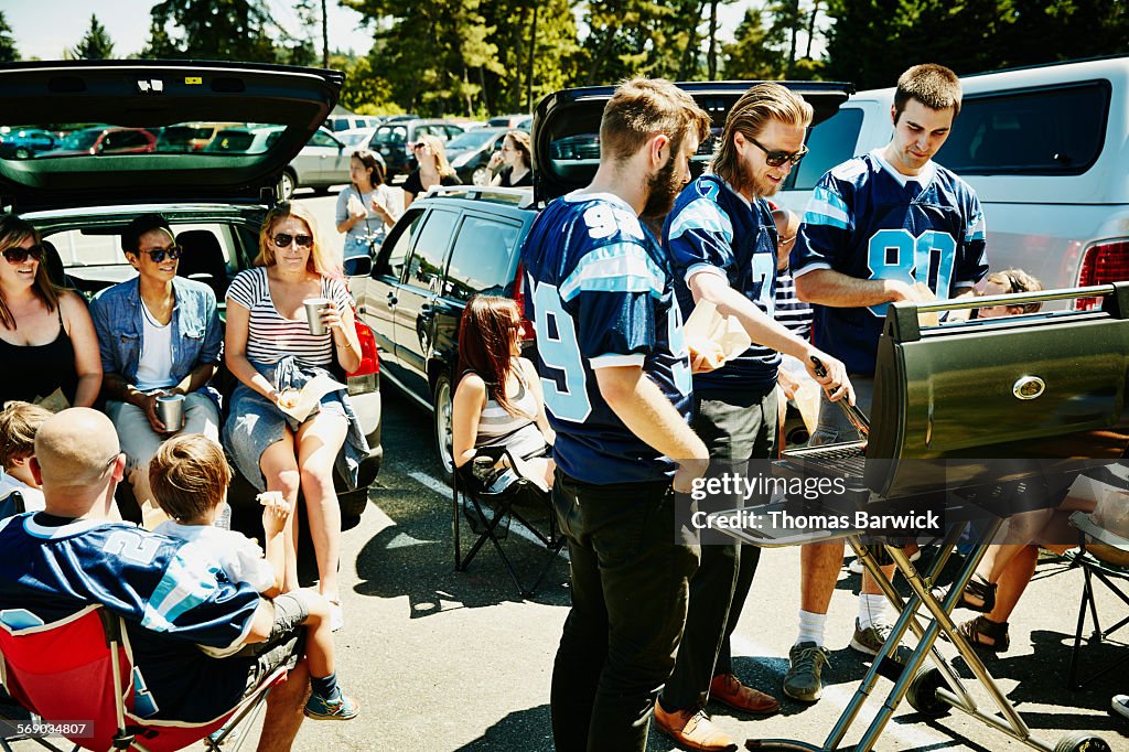 Friends barbecuing during tailgating party