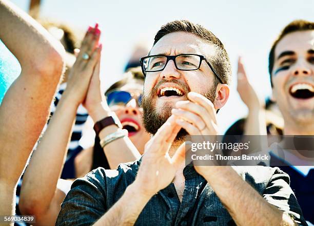 fan celebrating during football game in stadium - match for solidarity stock pictures, royalty-free photos & images