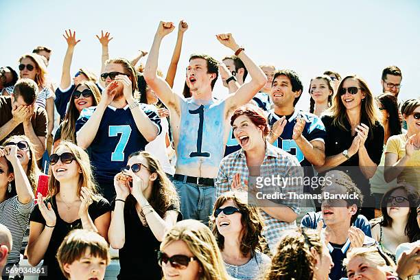 crowd of football fans celebrating during game - pre game stockfoto's en -beelden