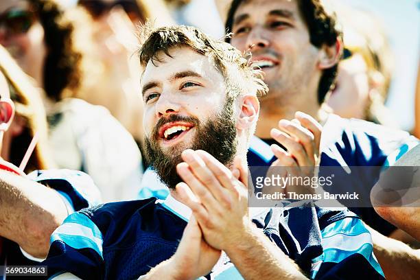 football fan clapping with crowd in stadium - man wearing sports jersey stock pictures, royalty-free photos & images