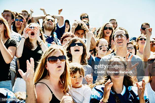 disappointed crowd in stadium watching team lose - boomwa stock pictures, royalty-free photos & images