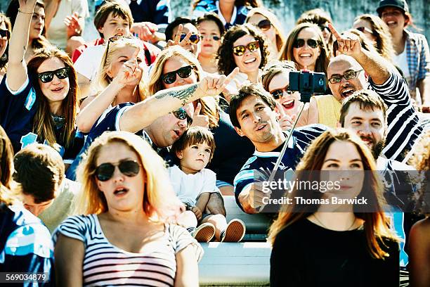 group of friends at football game taking selfie - asian games day 9 stock-fotos und bilder