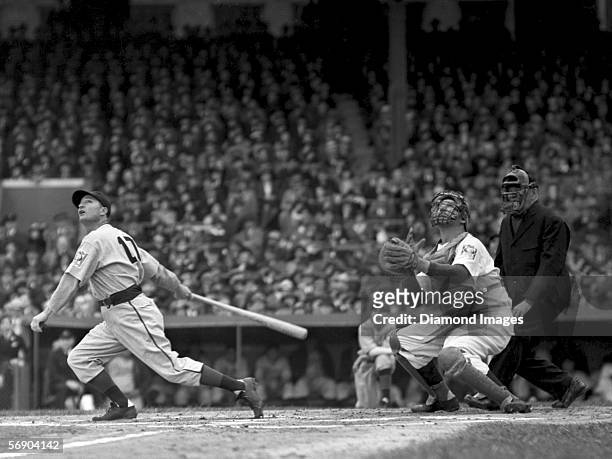 Outfielder Lloyd Waner of the Pittsburgh Pirates pops up a pitch as catcher Ernie Lombardi of the Cincinnati Reds looks to see if he has a play...