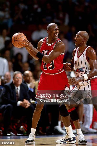 Michael Jordan of the Chicago Bulls keeps the ball away from Clyde Drexler#22 of the Houston Rockets during an NBA game at the Summit circa 1996 in...