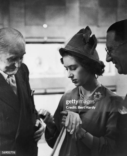 Princess Margaret Rose attends an exhibition of work by Russian jeweller Peter Carl Faberge at Wartski on Regent Street, December 1949. Here she...