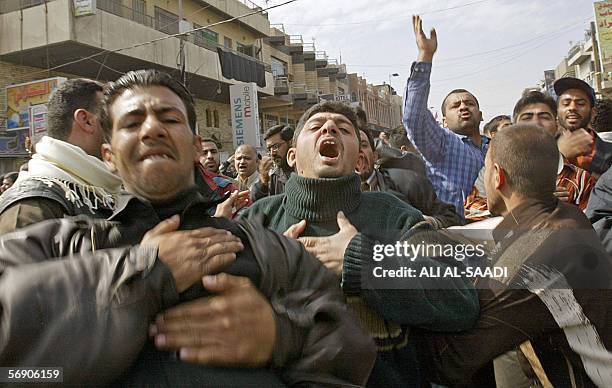 Angry Iraq Shiites demonstrate in Baghdad's al-Kazemiya district to protest the bombing if the holy shrine of al-Hadi in the Iraqi northern city of...