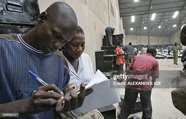 Ugandan Electoral Commission workers prepare ballot boxes in Kampala 22 Febuaray 2006 for the 23 February 2006 presidential election, the first...