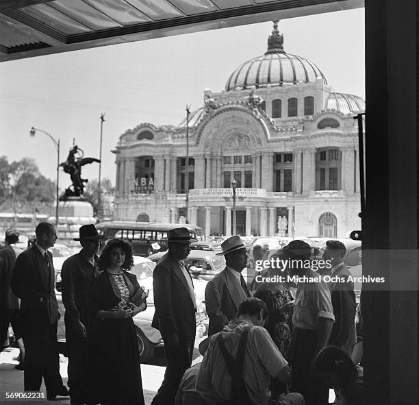 Pedestrians walk across the street from The Palacio de Bellas Artes in Mexico City, Mexico.