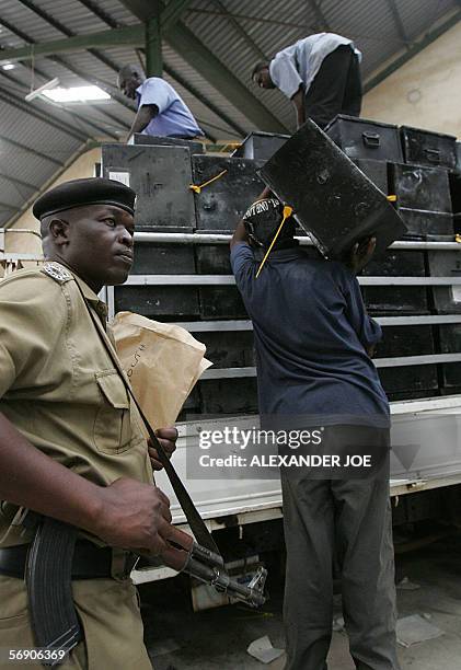 Ugandan Electoral Commission workers load ballot boxes under the supervison of police in Kampala 22 Febuaray 2006 for the 23 February 2006...