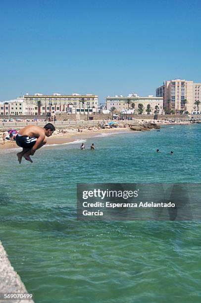 Boy jumping into the sea, Cadiz, Spain