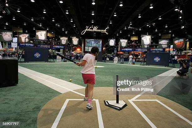 Young fans try out the T-ball field at the John Hancock Major League Baseball All-Star Fan Fest at the COBO Center on July 9, 2005 in Detroit,...