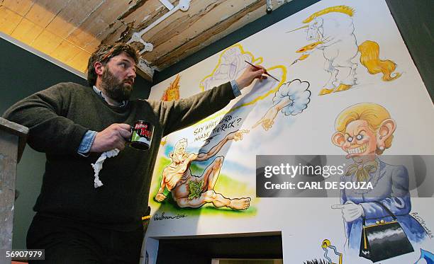 London, UNITED KINGDOM: Cartoonist Steve Bell paints a mural at a new cartoon gallery in London, 22 February 2006. The museum will showcase over...