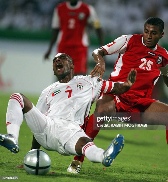 Dubai, UNITED ARAB EMIRATES: Emirati player Mohammed Omar fights for the ball with Omani player Khalifa Al-Nawfal during their national teams' Asian...