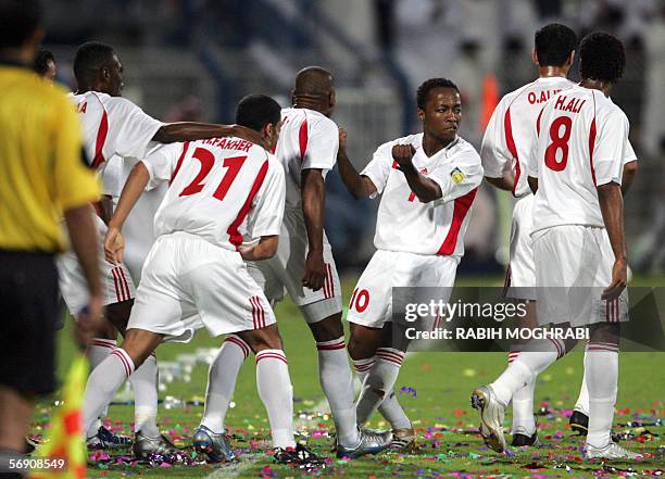 Dubai, UNITED ARAB EMIRATES: Emirati player Ismail Matar celebrates with his comrads after scoring the first goal against Oman during their Asian Cup...