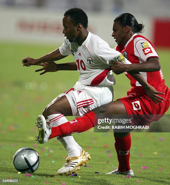 Dubai, UNITED ARAB EMIRATES: Emirati player Ismail Matar fights for the ball with Omani player Ahmed Al-Mahaijri during their national teams' Asian...