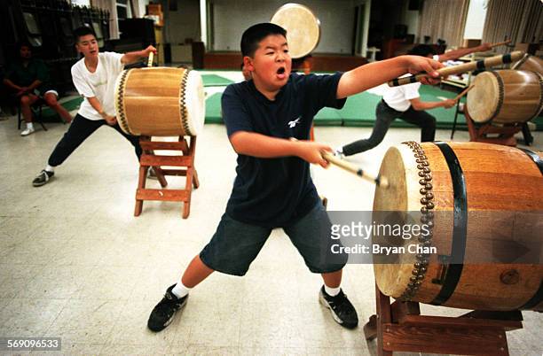 Ken Iwamoto lets out yell while practicing with fellow taiko drumers for a performance at the Fujimatsuri Festival at the Bhuddist Church of Oxnard...