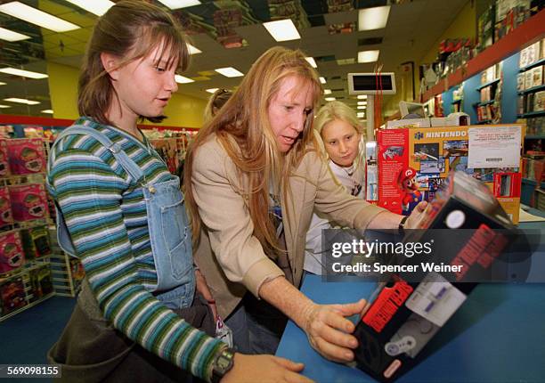 Patty Crisp##cq%%##center%% shops with her daughters##left%% Alicia and Darby at the KB toy store at the Esplanade Mall in Oxnard. The group spent...