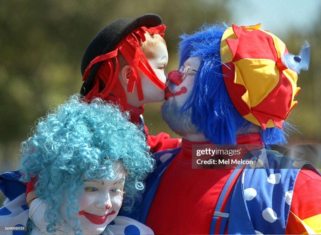 Fred Harshberger gives his son Ryan, 3, a kiss while performing as clowns during the Simi Valley Day
