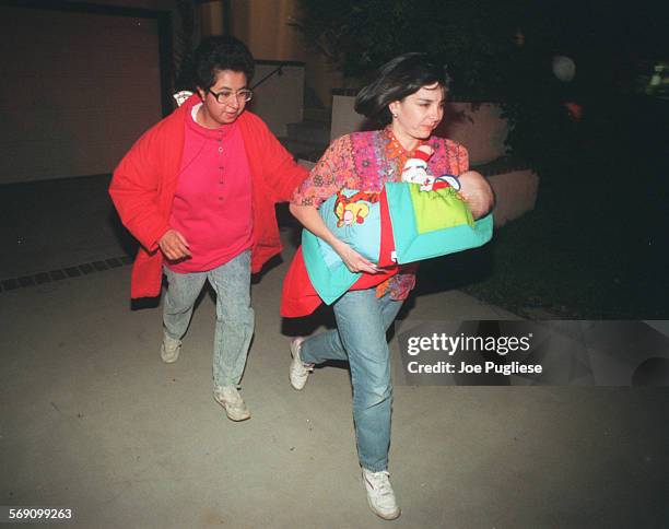 Karen Carlson carries her baby while evacuating from her home on aliso canyon in ventura.