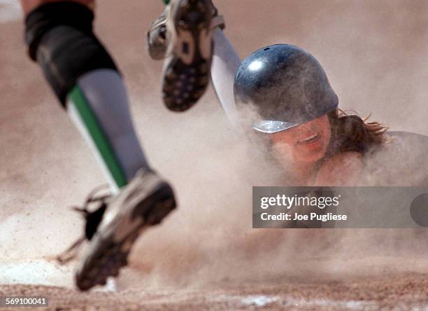 Camarillo High's Jessica Mendoza is out as she slides back into first base, ending the game in the seventh inning during Thousand Oaks High's 20...