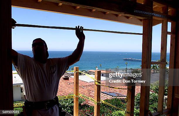 San ClementeFrank Earnest, who works for Birch Construction Company of Dana Point, measures a window opening on an second story addition to a...