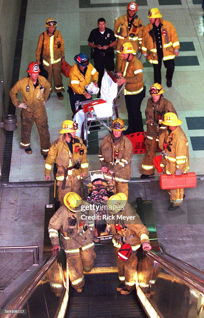 018381.ME.1025.fall1.rm LA City Fire Fighters remove female victim from Metro Red Line civic center 