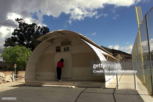 Tuesday, , Piru, CA  DIGITAL IMAGE  Stephanie Acosta, of Piru, opening the Piru Scout House, an old WWII quonset hut, which holds a lot of memories...