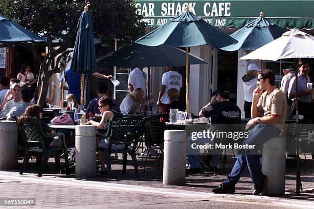 Customers enjoying the outdoor dining at the Sugar Shack Cafe on Main Street in Huntington Beach.A proposal currently under consideration by the...