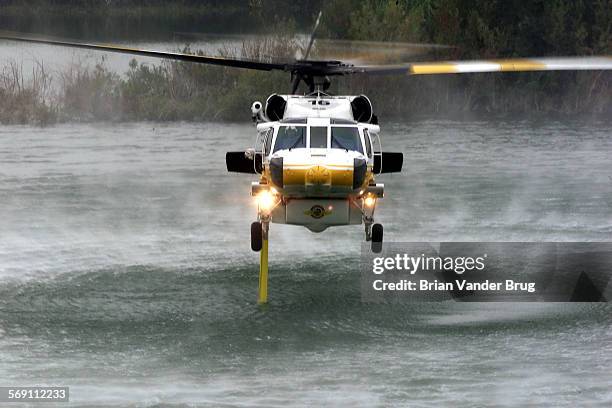 One of LA County's new Sikorsky S70A Firehawk helicopters pumps water into it's 1000gallon water tank from Hansen Dam Recreation Area during a...