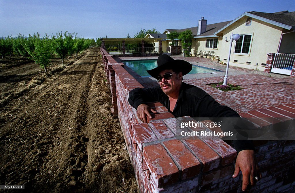 028472.ME.0423.mexelect.13.RLWinters,Ca. Andres Bermudez poses with the house he has recently bu