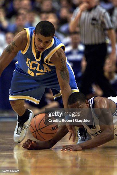 S Earl Watson battles Duke's Chris Duhon for a loose ball during first half action of NCAA Eastern Regional semi final game in Philadelphia on...