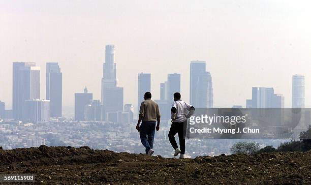 Dasol , 56 and wife Paulette Mashaka of Carson enjoy the view of the Los Angeles skyline from an empty lot off Mulholland Drive in Studio City on...
