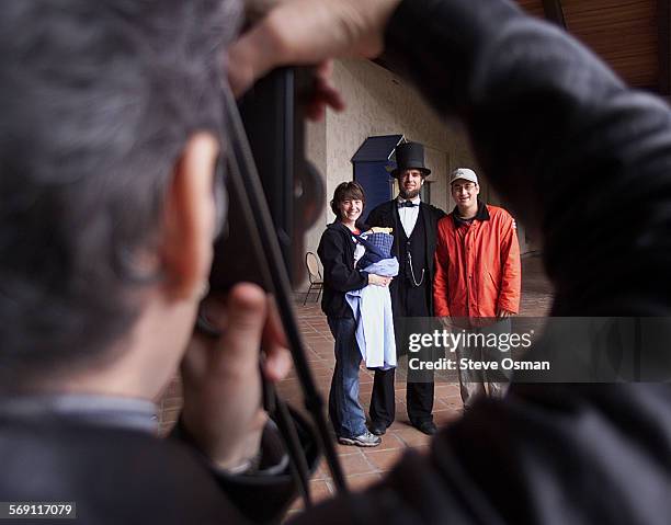 Don Justice, of Kentucky, takes a photo of daughter Tamra Misseijer, left, holding son Chandler 3 mos., Abraham Lincoln, aka John Kendall, and...