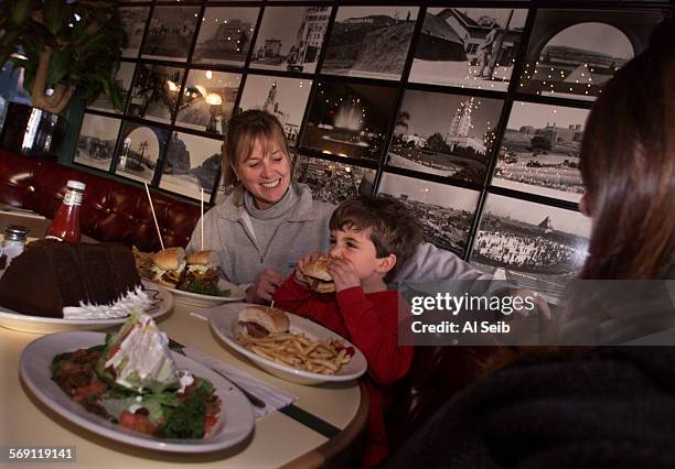 Counter21.6.AS Kerry Morris with her son 4 year old Timothy Morris enjoying food at Bob Morris's Beverly Hills BBQ. This is an old barbecue palace...