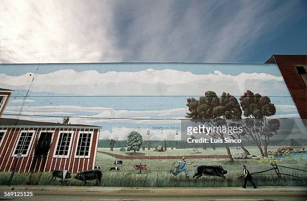 Vernon.3.LS. Mural of pastoral scene covers southern wall of Farmer John meat processing plant in Vernon, a primarily industrial area southeast of...