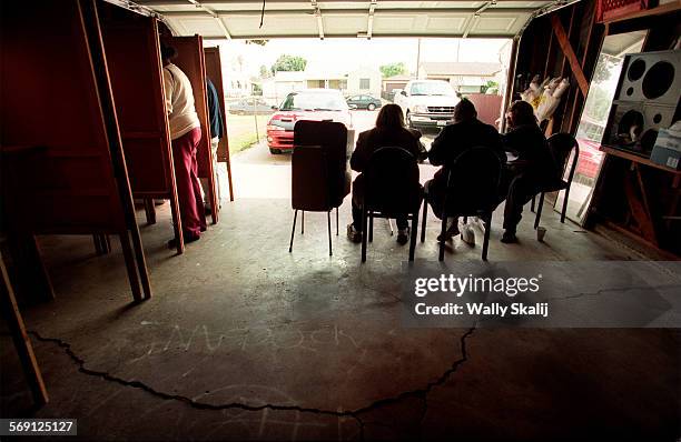 Volunteers wait for voters in a garage on Harris Avenue in Compton Tuesday. Voters from the community turned out to cast their vote during this Super...