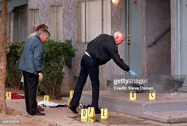 Oxnard Police Department evidence tech. Bob Morgan marks evidence along with Det. Michael Palmier and Sgt. Lee Wilcox. At scene of shooting, on Clara...