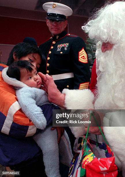 Toysfortots#4.1220.RLSupai,Az.Santa Claus visits with one of the Havasupai Indian Reservation children during a Toys for Tots mission into the...