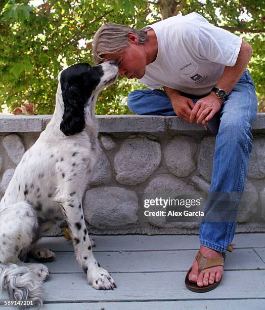 Vincent.chair.0725.AAGActor JanMichael Vincent nuzzles his dog Buckwheat at their Coto de Caza home. He said having a dog has helped him deal with...