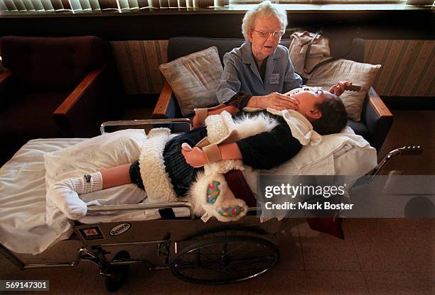 Fairview.Grandmother.052898.MBDavida McFarland, a volunteer with the Foster Grandparent program talks to patient "Vinnie" at the Fairview...