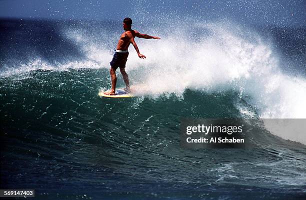 Tamarindo.wingnut.0417.ASPLAYA NEGRA, COSTA RICASurfing movie star Robert "Wingnut" Weaver rides a Playa Negra wave on the nose of his longboard,...