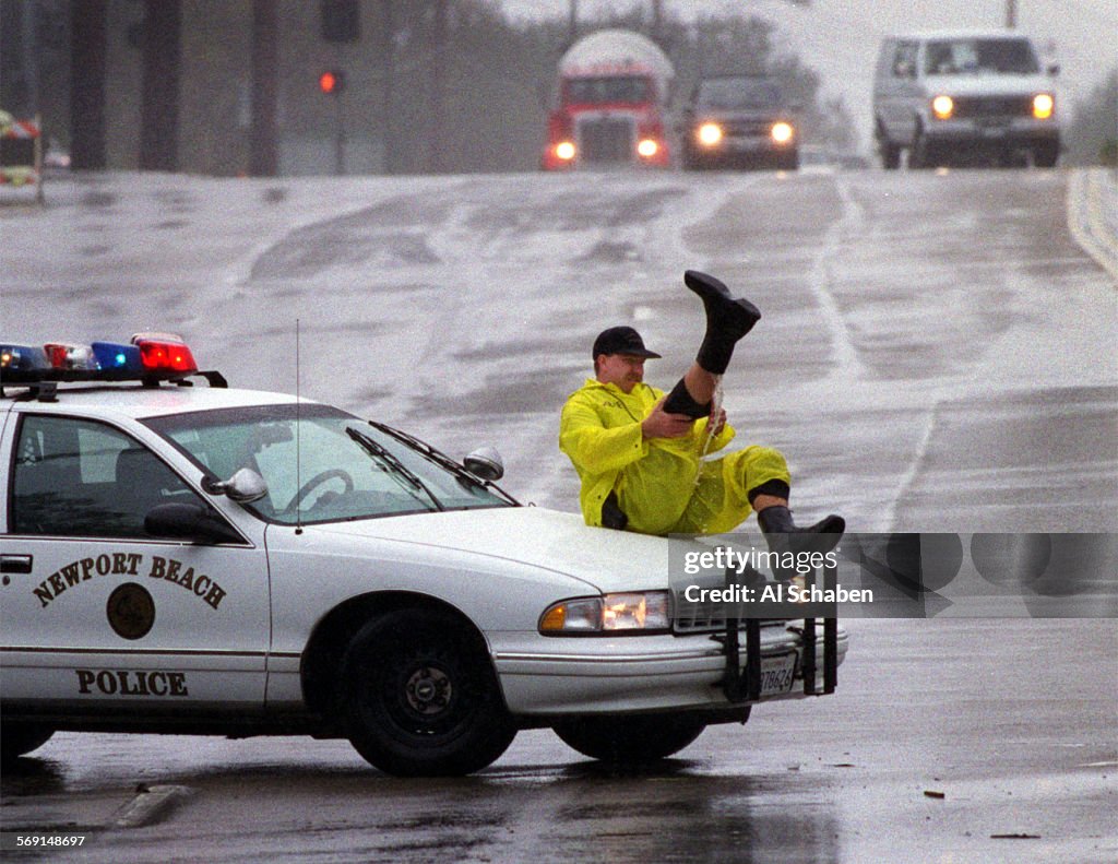 AA.storm.flood.cop.0206.ASNEWPORT BEACHA Newport Beach police officer prepares himself for heavy