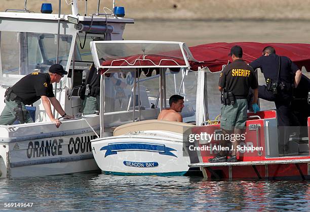 Orange County Sheriff's Harbor Patrol try to convince a man wanted for boat theft to surrender in a stolen Duffy electric boat during an hour-long...