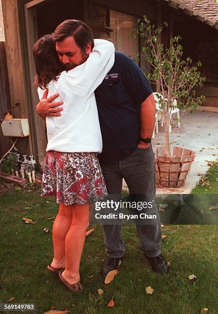 Neighbor Margie Kleber gives comfort to Floyd Leech whose wife was killed in the robbery of Western Financial Bank in Thousand Oaks.