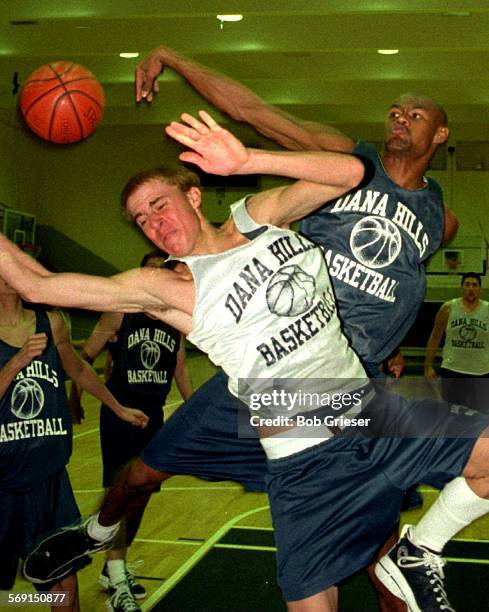 Souza/block.3/3.BG.23dec96--Huber Souza a foreign exchange student from Brazil leaps up and blocks a layup by a teammate during practice at Dana...