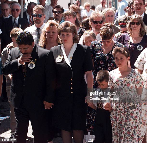 Beaumont.2.0426.GFBEAUMONT Ernesto and Diana Medina walk in front of family memebrs as they enter the memorial service for their son, Anthony...