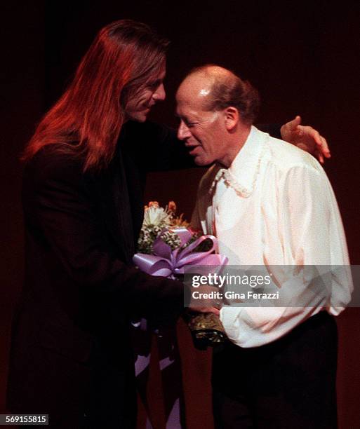 Helfgott.1.0325.GFPianist David Helfgott gets flowers and a hug from Scott Hicks, director of the movie Shine, after Helfgott performed at the...