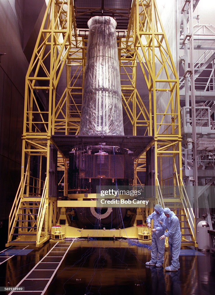 FI.TRW.3.0130.bc.gTwo TRW technicians are dwarfed by the Advanced XRay Astrophysics Facility sat